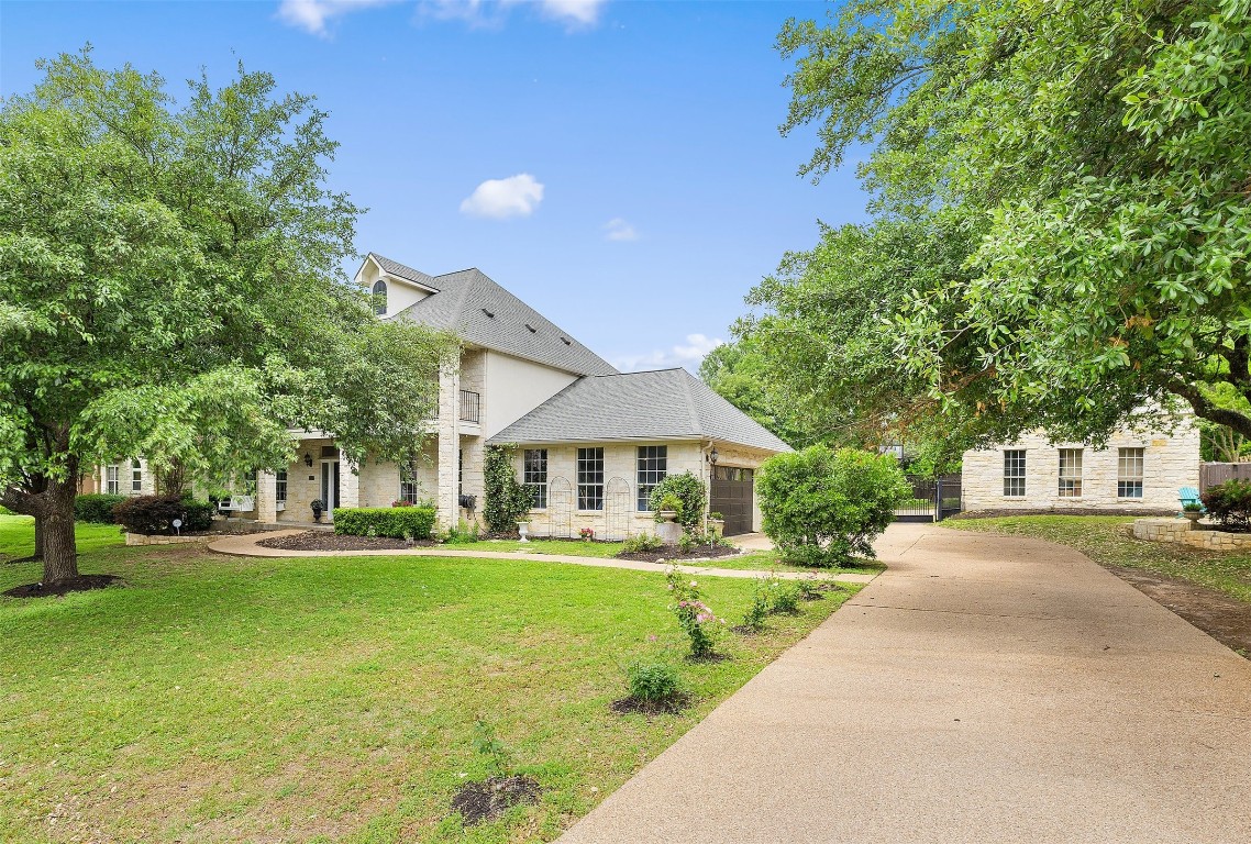 a front view of house with yard and green space
