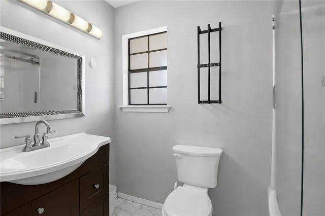 a bathroom with a toilet sink and mirror