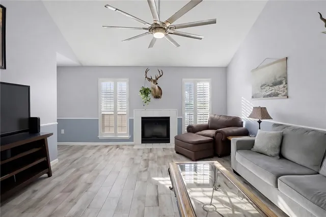 a living room with furniture a fireplace and a flat screen tv