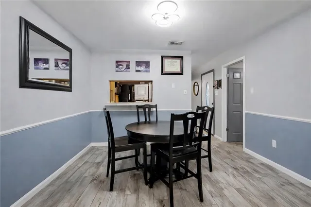 a view of a dining room with furniture and wooden floor