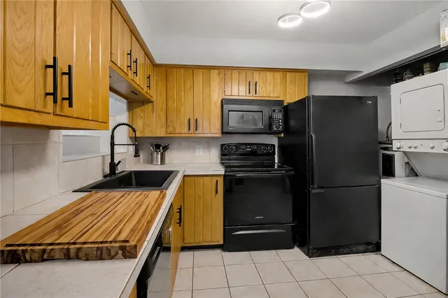 a kitchen with a refrigerator and a sink