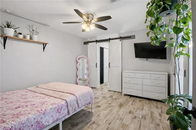 a bedroom with a bed window and a flat screen tv
