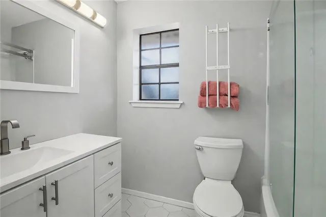 a bathroom with a toilet sink and mirror