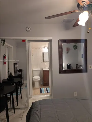 a living room with furniture and a painting on the wall