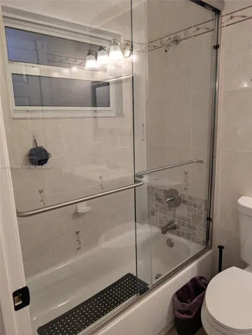 a bathroom with a shower and a toilet