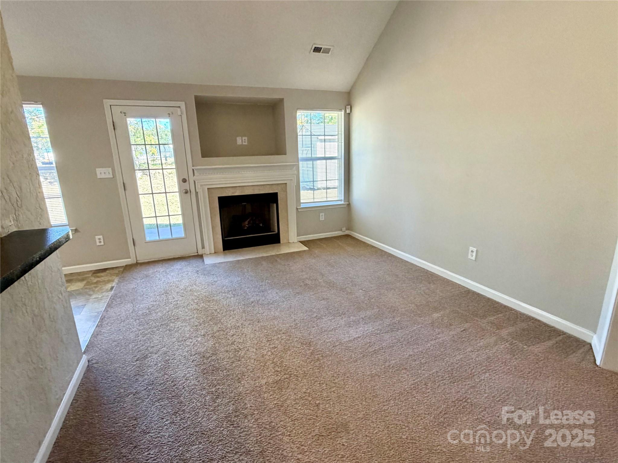 910 Rucker Cliff Drive Charlotte, NC 28214 - Photo 3 of 23 an empty room with a fireplace