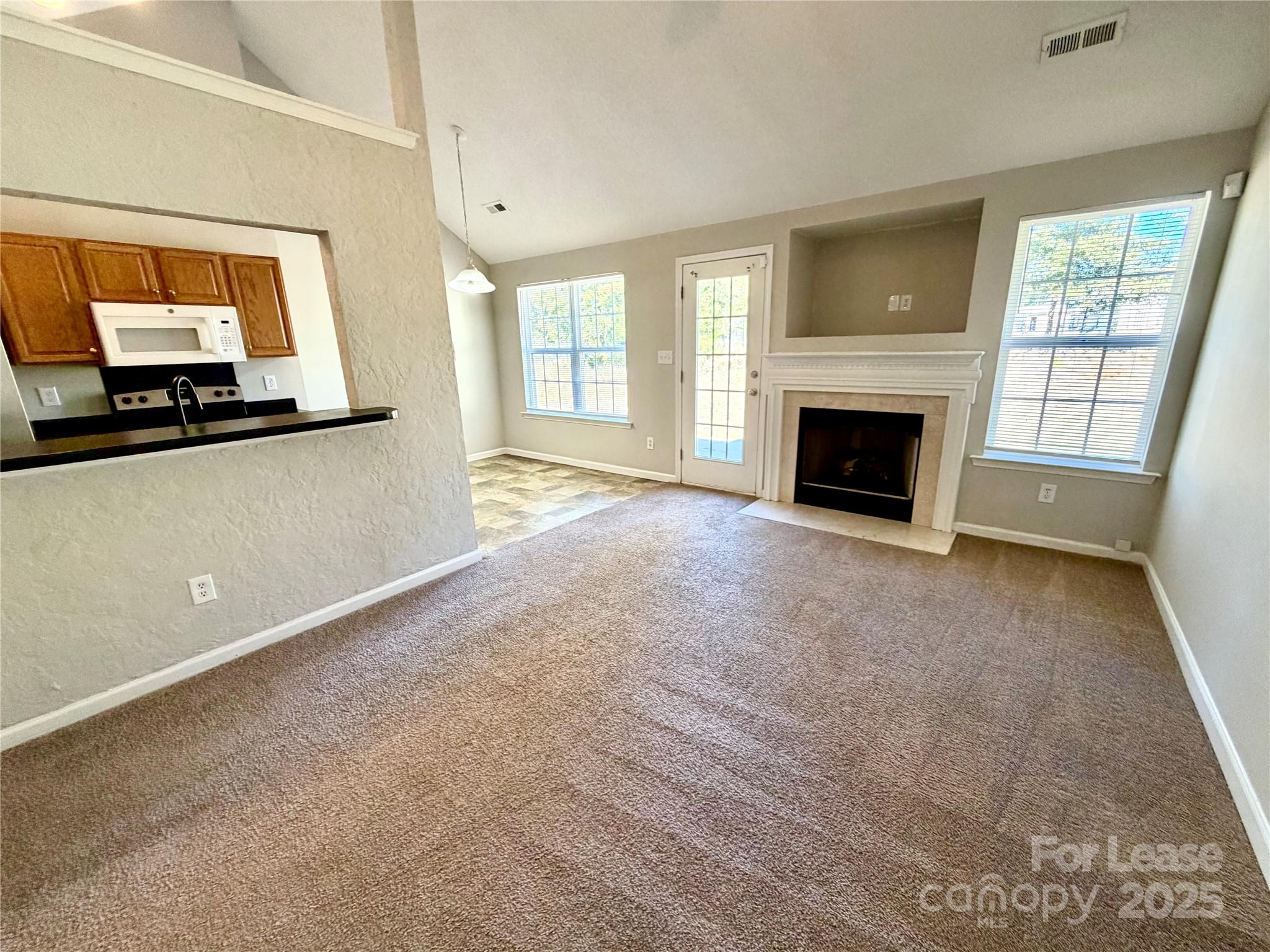 910 Rucker Cliff Drive Charlotte, NC 28214 - Photo 4 of 23 a view of a livingroom with a fireplace and window