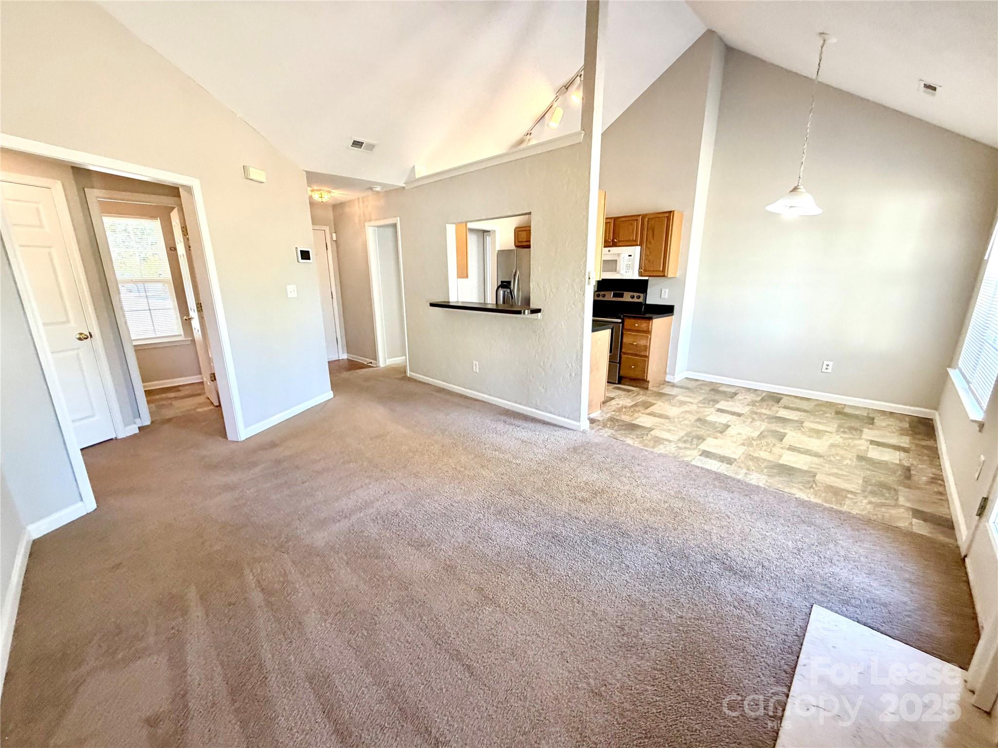 910 Rucker Cliff Drive Charlotte, NC 28214 - Photo 5 of 23 a view of a big room with wooden floor and a kitchen