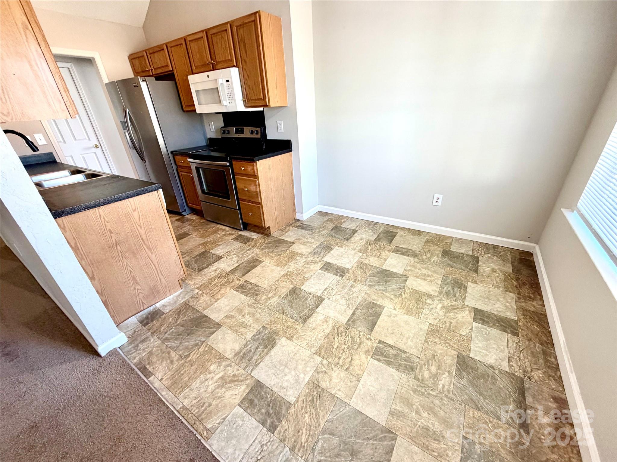 910 Rucker Cliff Drive Charlotte, NC 28214 - Photo 10 of 23 a view of kitchen island with wooden floor