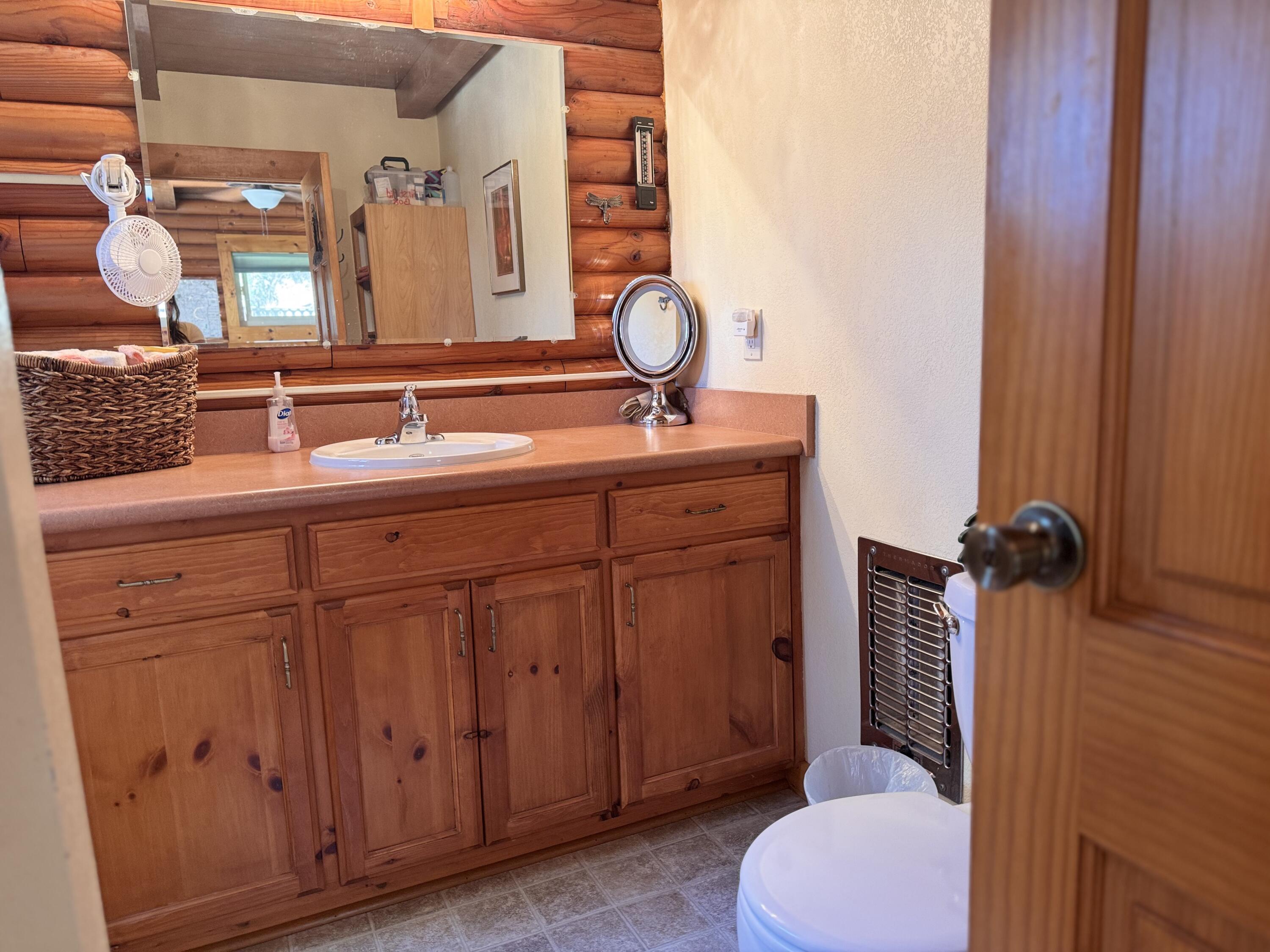 51911 Hogback Miramonte, CA 93641 - Photo 31 of 49 a bathroom with a toilet a sink and mirror
