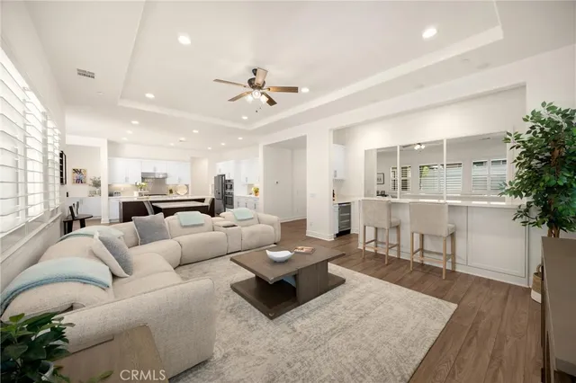 a kitchen with kitchen island wooden floors appliances and white center