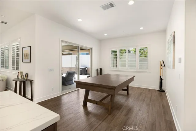 a spacious bedroom with a bed and a flat screen television