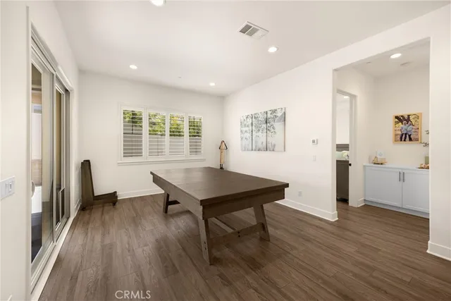 a spacious bedroom with a bed and a chandelier