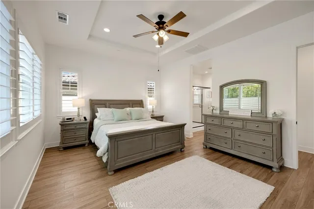 a en suite bathroom with a granite countertop sink and a mirror
