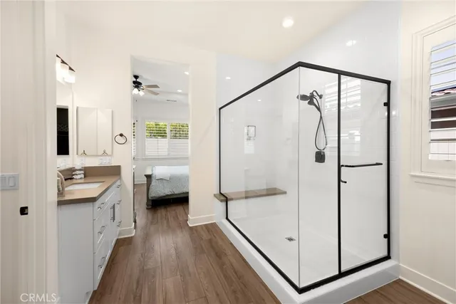 a spacious bedroom with a bed and a chandelier