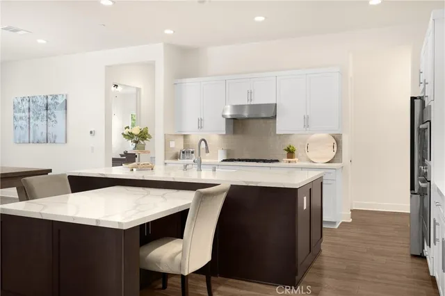 a living room with furniture a flat screen tv and a large window