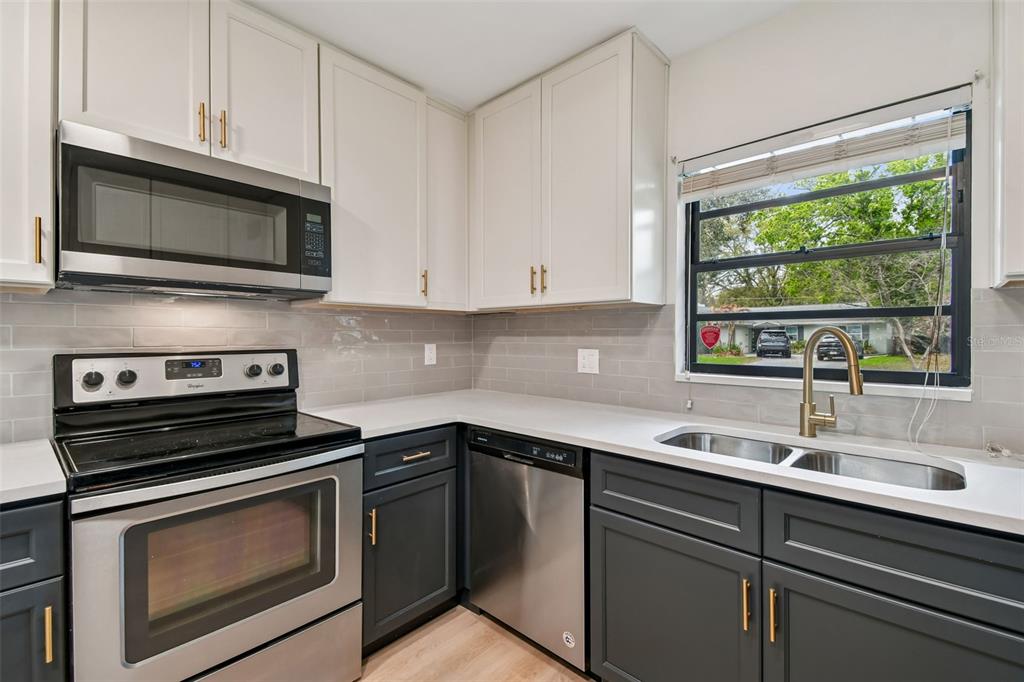2708 Lion Heart Road Winter Park, FL 32792 - Photo 11 of 47 a kitchen with a sink stove and microwave