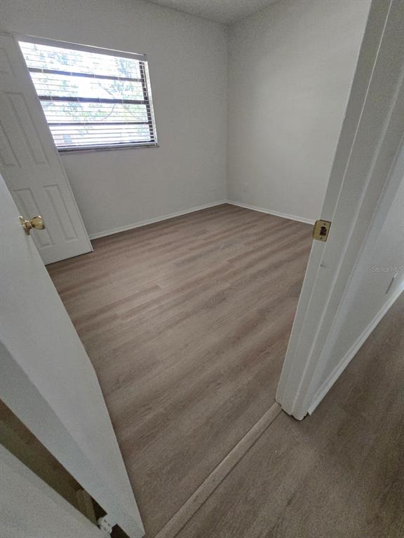 2708 Lion Heart Road Winter Park, FL 32792 - Photo 28 of 47 a view of an empty room with wooden floor and a window