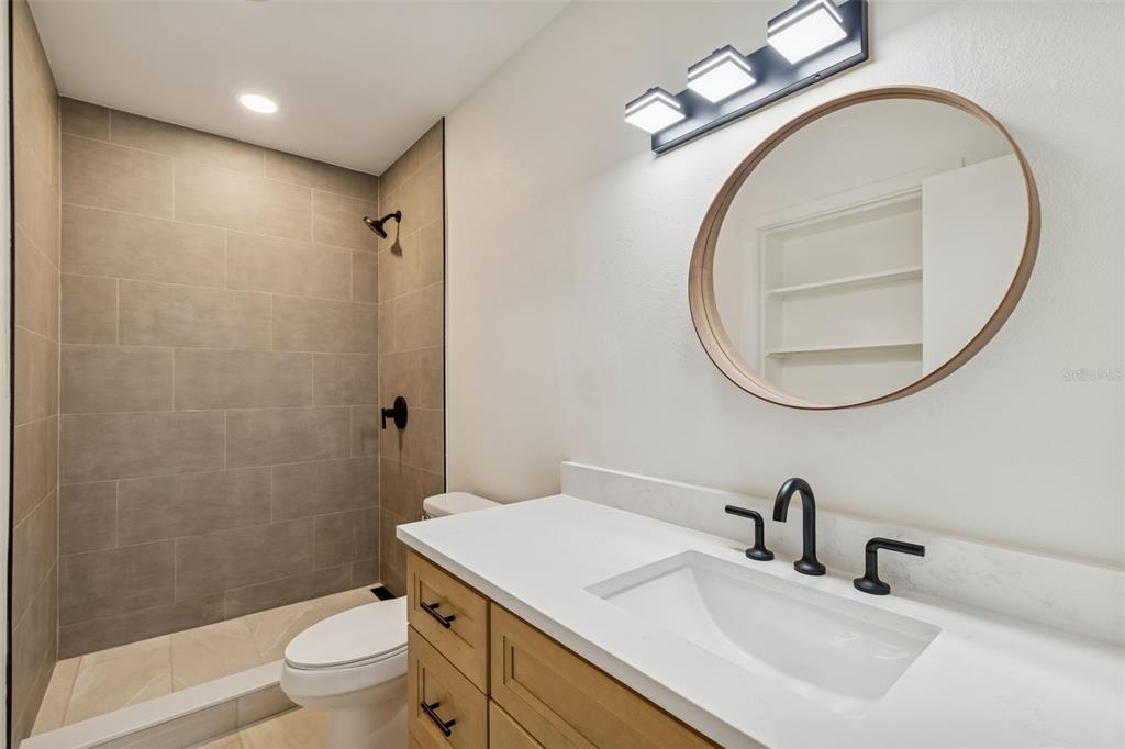 2708 Lion Heart Road Winter Park, FL 32792 - Photo 30 of 47 a bathroom with a sink a toilet and a mirror