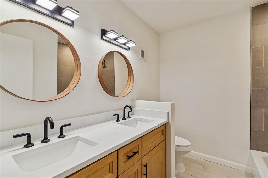 2708 Lion Heart Road Winter Park, FL 32792 - Photo 33 of 47 a bathroom with a sink a toilet and a mirror