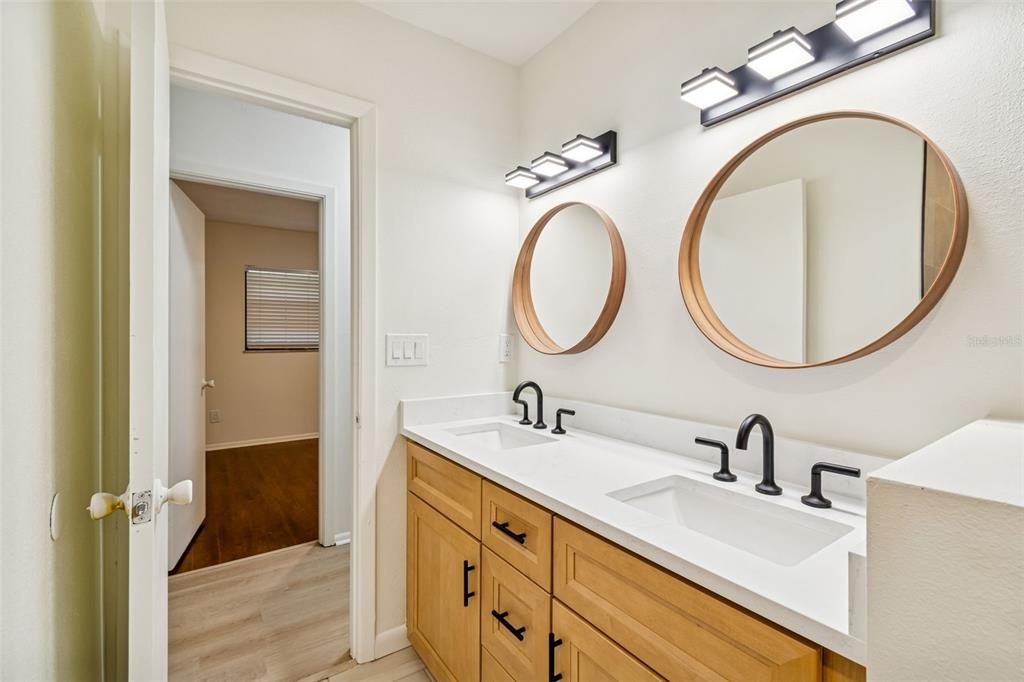 2708 Lion Heart Road Winter Park, FL 32792 - Photo 35 of 47 a bathroom with a double vanity sink and a mirror