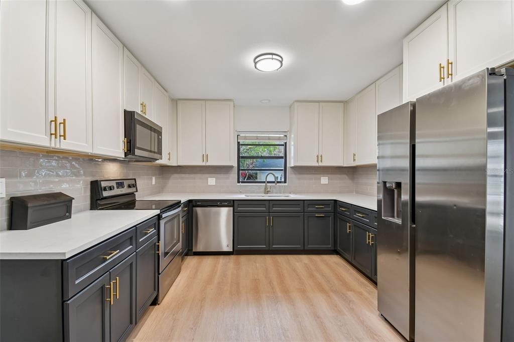 2708 Lion Heart Road Winter Park, FL 32792 - Photo 9 of 47 a kitchen with a sink stove and refrigerator