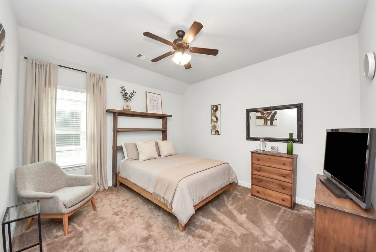 24503 Eucalyptus Way Spring, TX 77373 - Photo 13 of 27 a bedroom with a bed and a flat screen tv