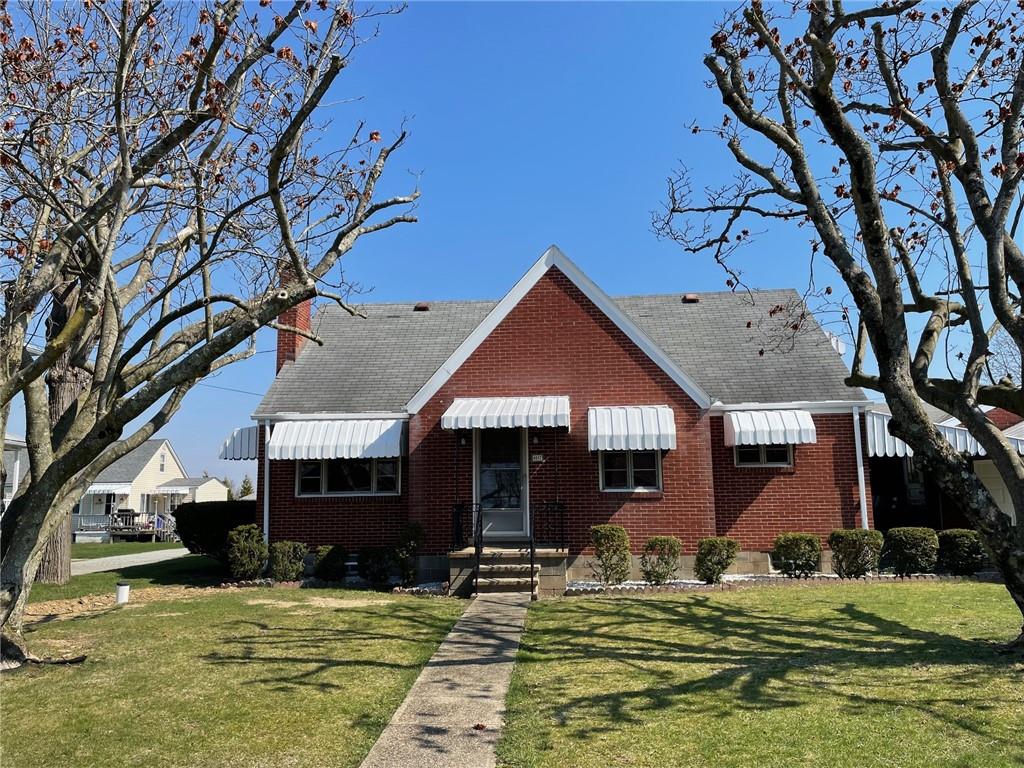 a backyard of a house with yard table and chairs