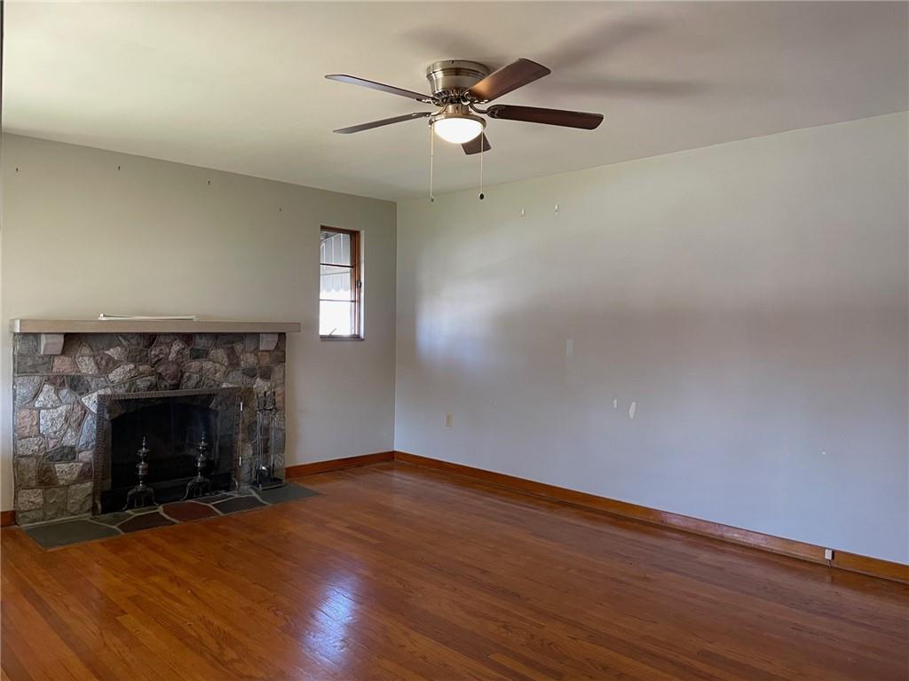 4517 Lincoln Avenue Jeannette, PA 15644 - Photo 12 of 37 an empty room with wooden floor fireplace and windows