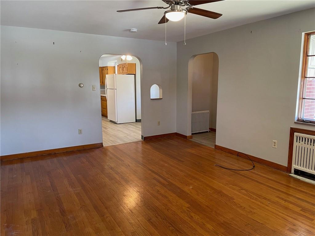4517 Lincoln Avenue Jeannette, PA 15644 - Photo 14 of 37 an empty room with wooden floor and windows