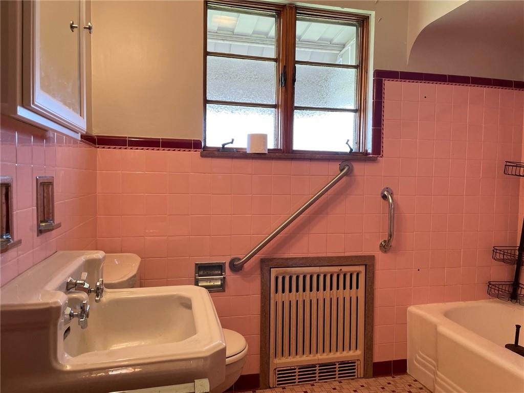 4517 Lincoln Avenue Jeannette, PA 15644 - Photo 15 of 37 a bathroom with a sink and a mirror