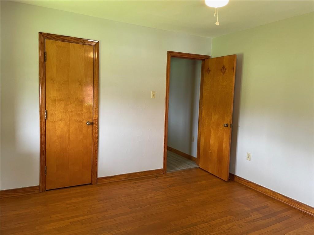4517 Lincoln Avenue Jeannette, PA 15644 - Photo 23 of 37 an empty room with wooden floor and closet area