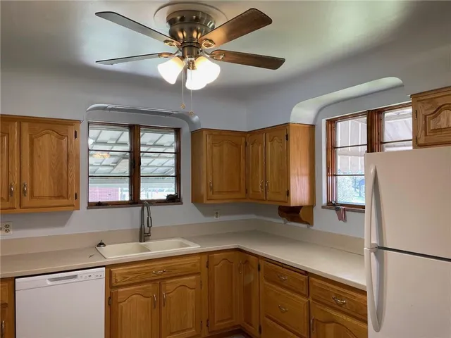 a kitchen with a sink cabinets and window