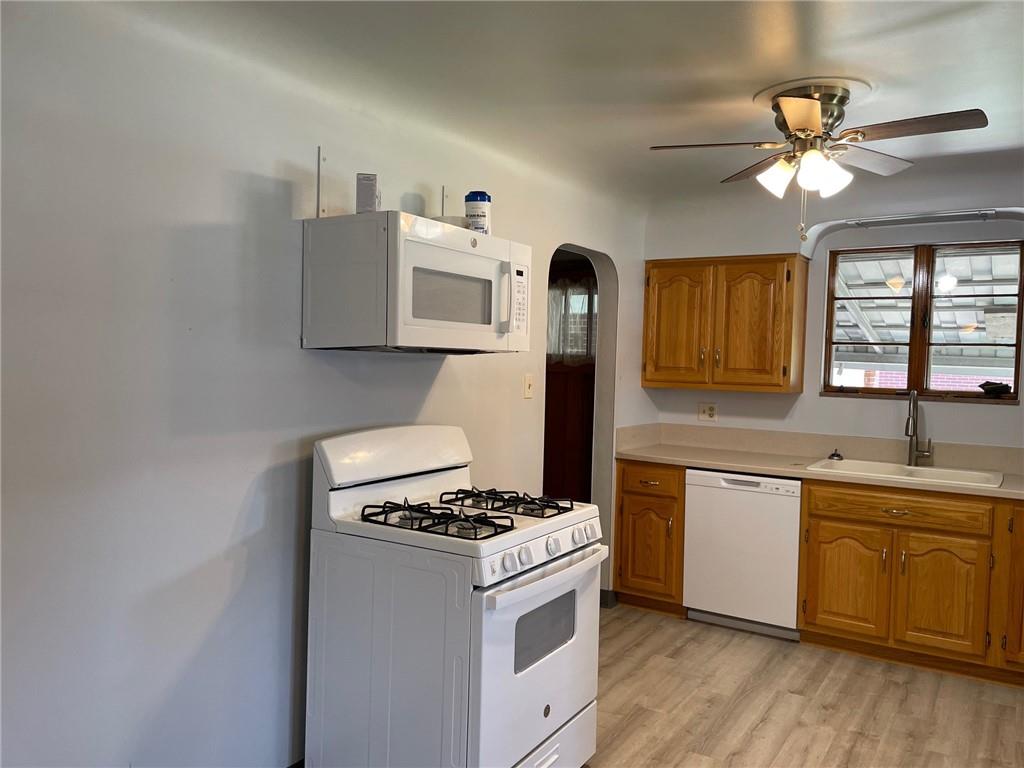 4517 Lincoln Avenue Jeannette, PA 15644 - Photo 6 of 37 a kitchen with stainless steel appliances a sink cabinets and wooden floor