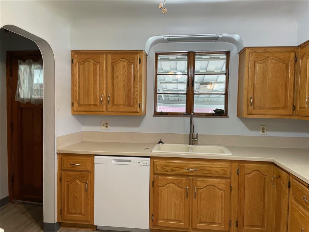 4517 Lincoln Avenue Jeannette, PA 15644 - Photo 7 of 37 a kitchen with stainless steel appliances granite countertop a sink and cabinets with wooden floor