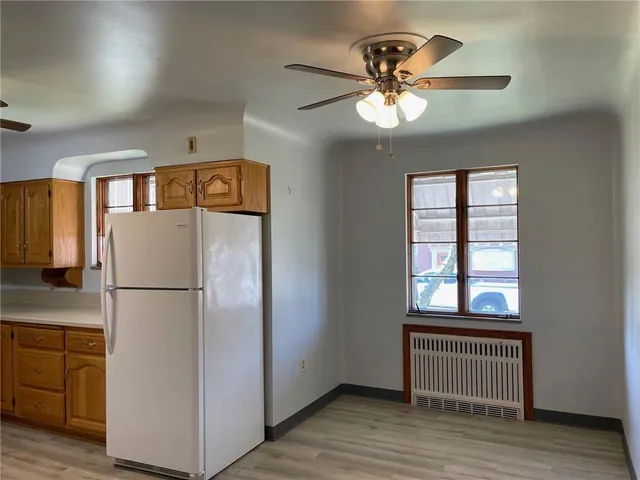 a white refrigerator freezer sitting inside of a kitchen