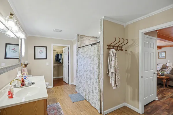 a bathroom with a shower sink and mirror