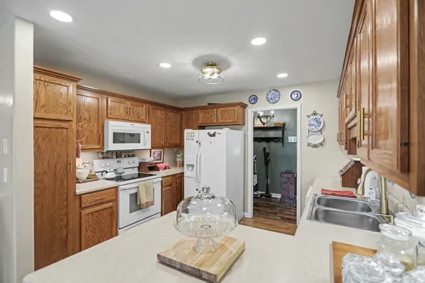 a kitchen with refrigerator cabinets and wooden floor