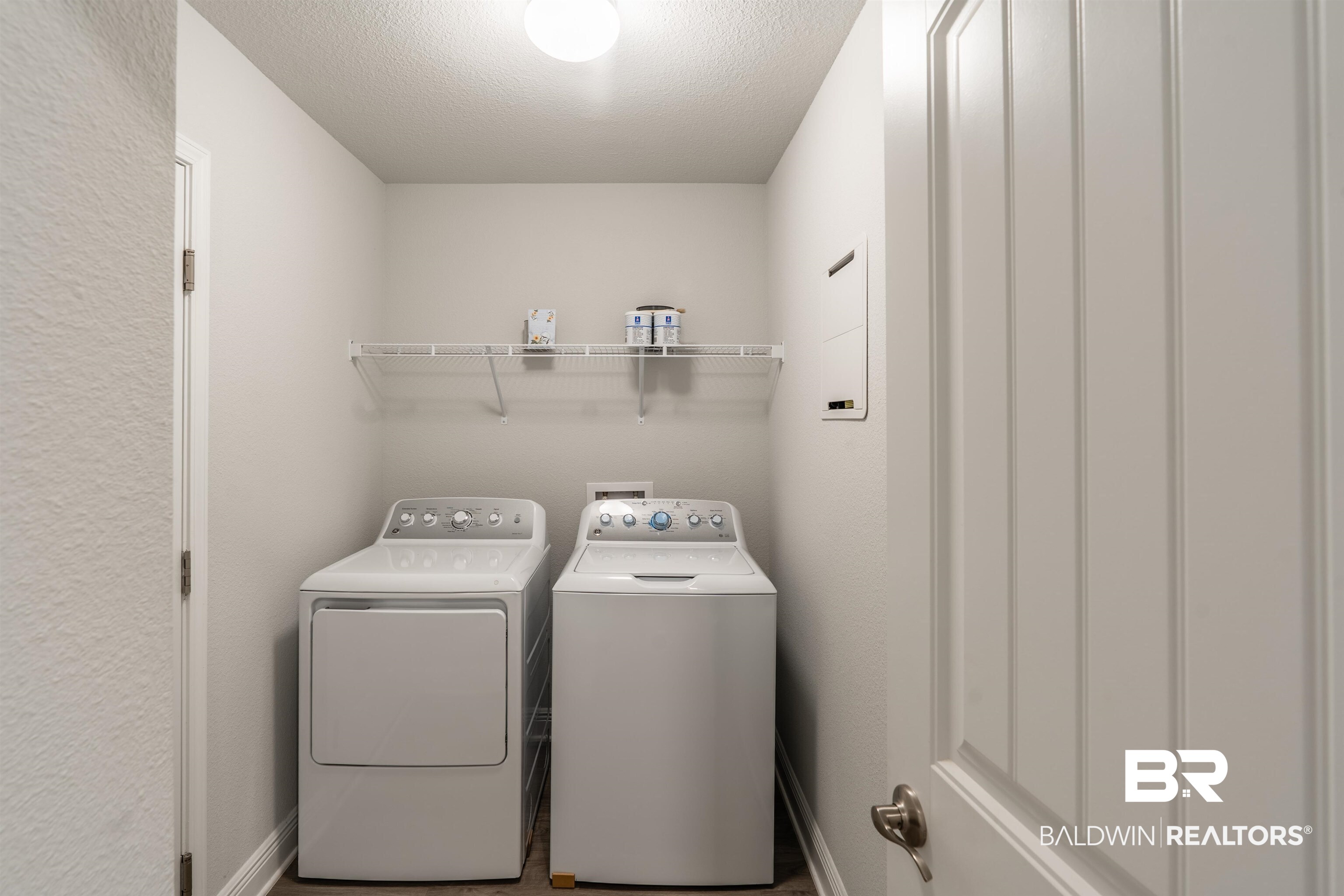 1906 Stonepine Drive South Semmes, AL 36575 - Photo 13 of 30 Laundry room with washing machine and clothes dryer, a textured ceiling, and a textured wall