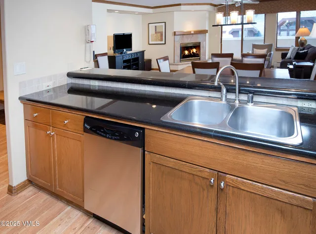 a kitchen with stainless steel appliances granite countertop a refrigerator sink and microwave