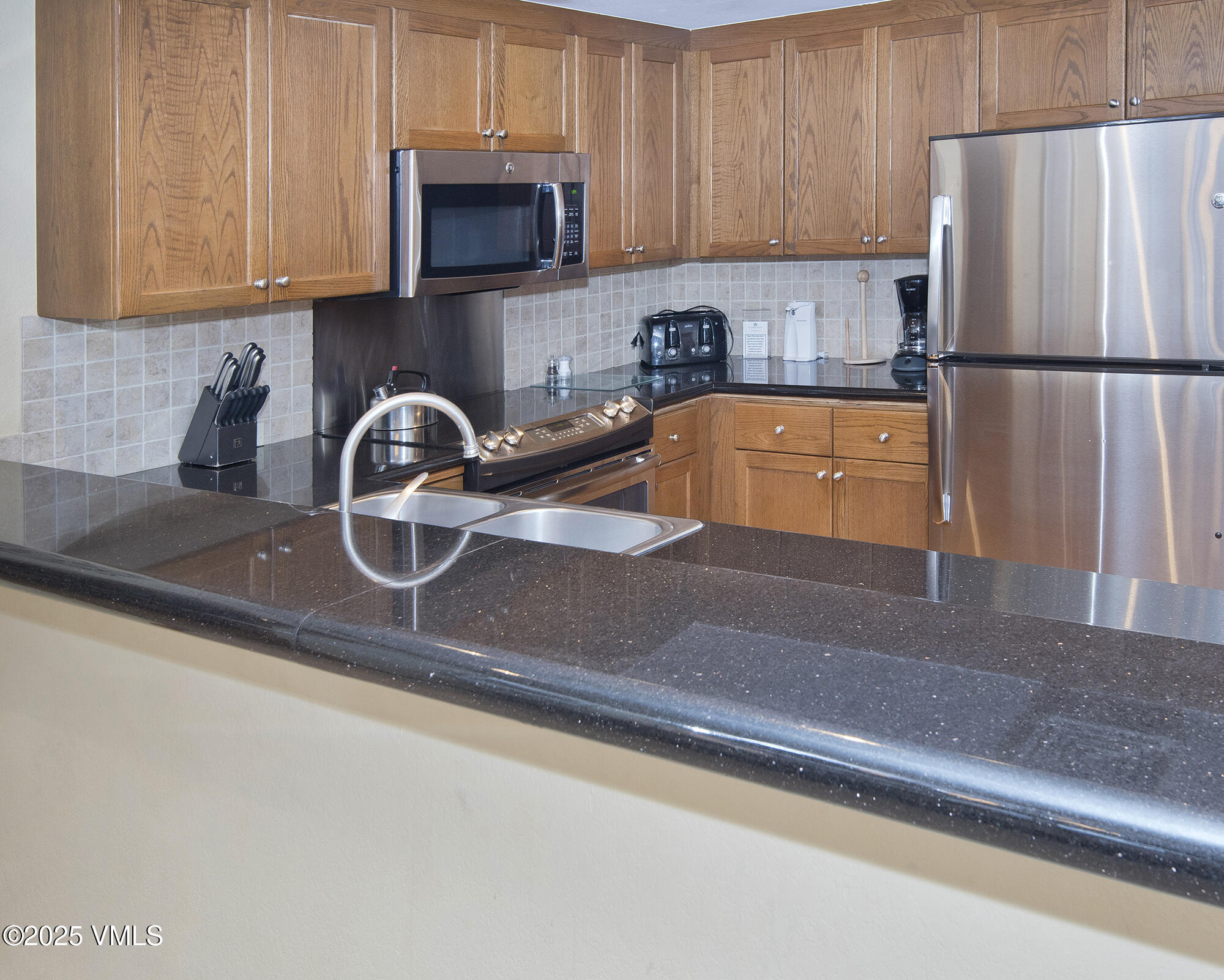210 Offerson Road Beaver Creek, CO 81620 - Photo 20 of 30 a kitchen with a refrigerator and a sink