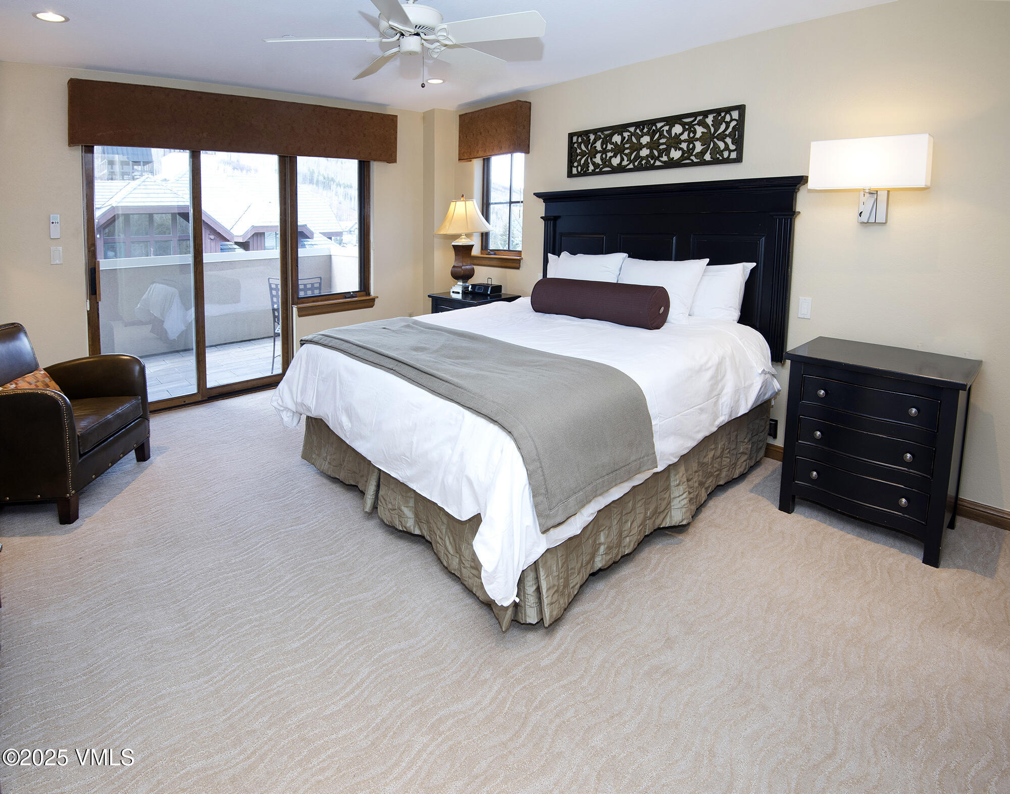 210 Offerson Road Beaver Creek, CO 81620 - Photo 22 of 30 a bedroom with a bed lamp and a large window