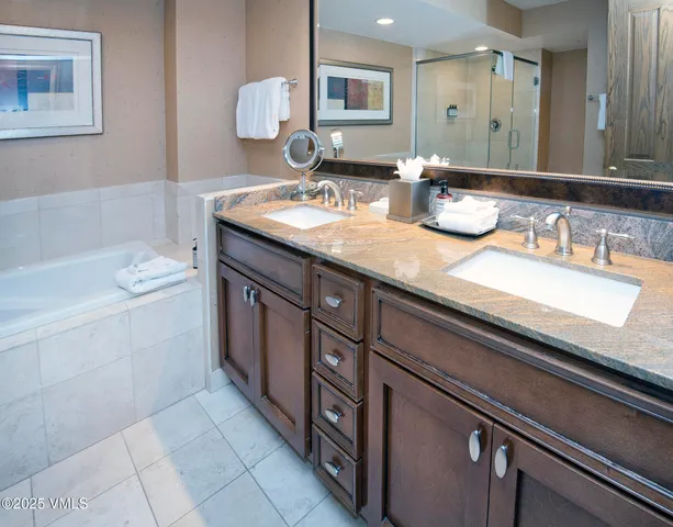 a spacious bathroom with a bathtub and shower