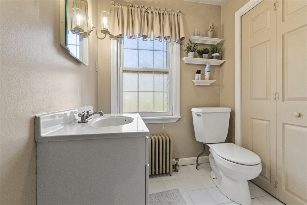 36 Forest Street Peabody, MA 01960 - Photo 17 of 35 a bathroom with a toilet sink and mirror