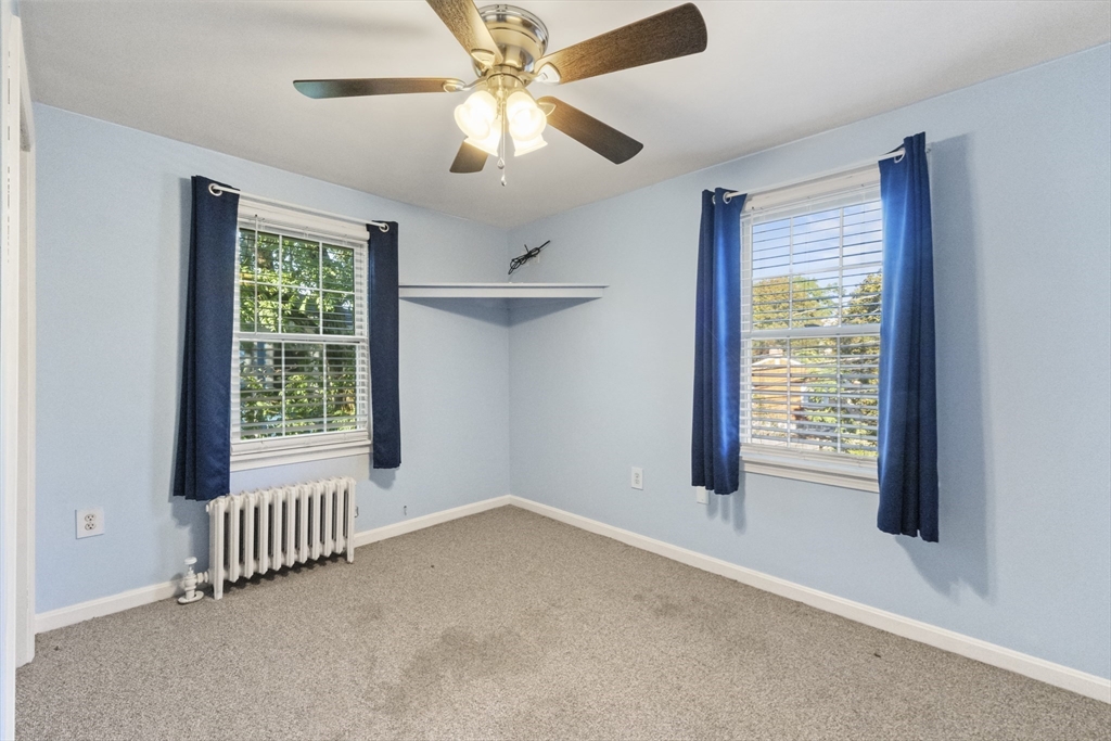 36 Forest Street Peabody, MA 01960 - Photo 19 of 35 an empty room with windows and fan