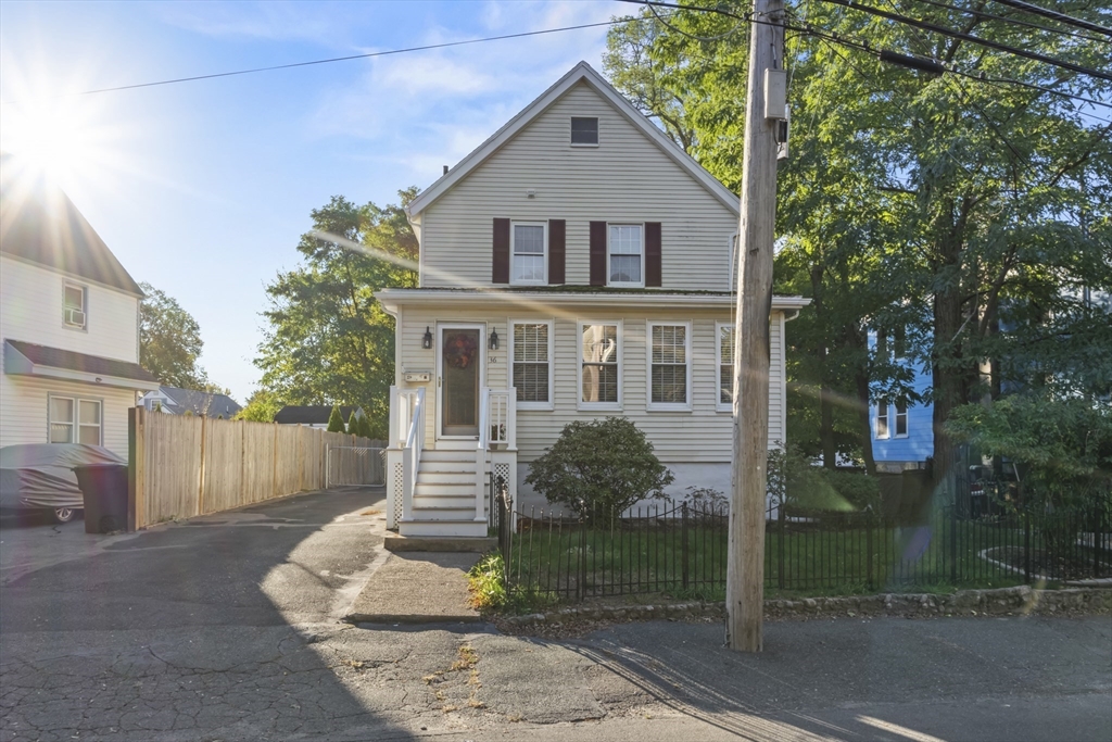 36 Forest Street Peabody, MA 01960 - Photo 28 of 35 a front view of a house with a yard and a garage