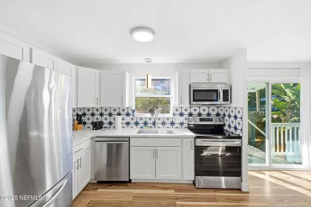 a kitchen with a stove a sink and a refrigerator
