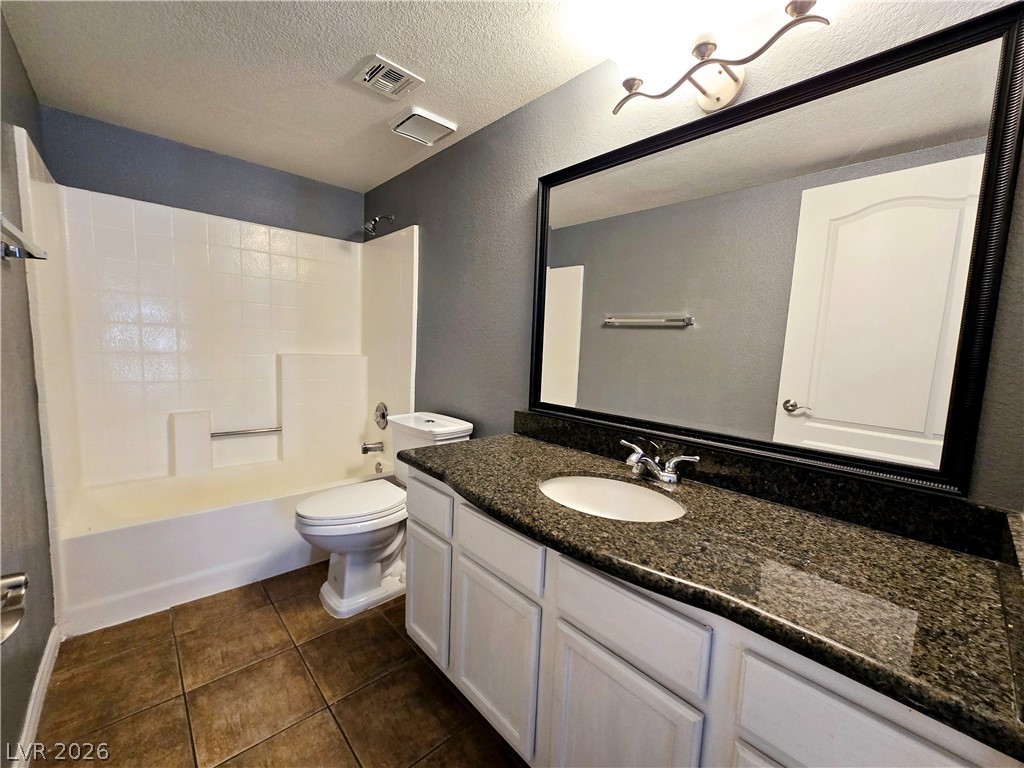 9325 West Desert Inn Road, Unit 229 Las Vegas, NV 89117 - Photo 15 of 17 Polished stone counters and durable tile flooring define this functional full bathroom.
