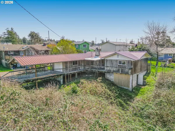 a view of house with swimming pool and outdoor seating