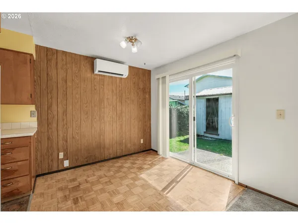 a view of an empty room with closet and a window
